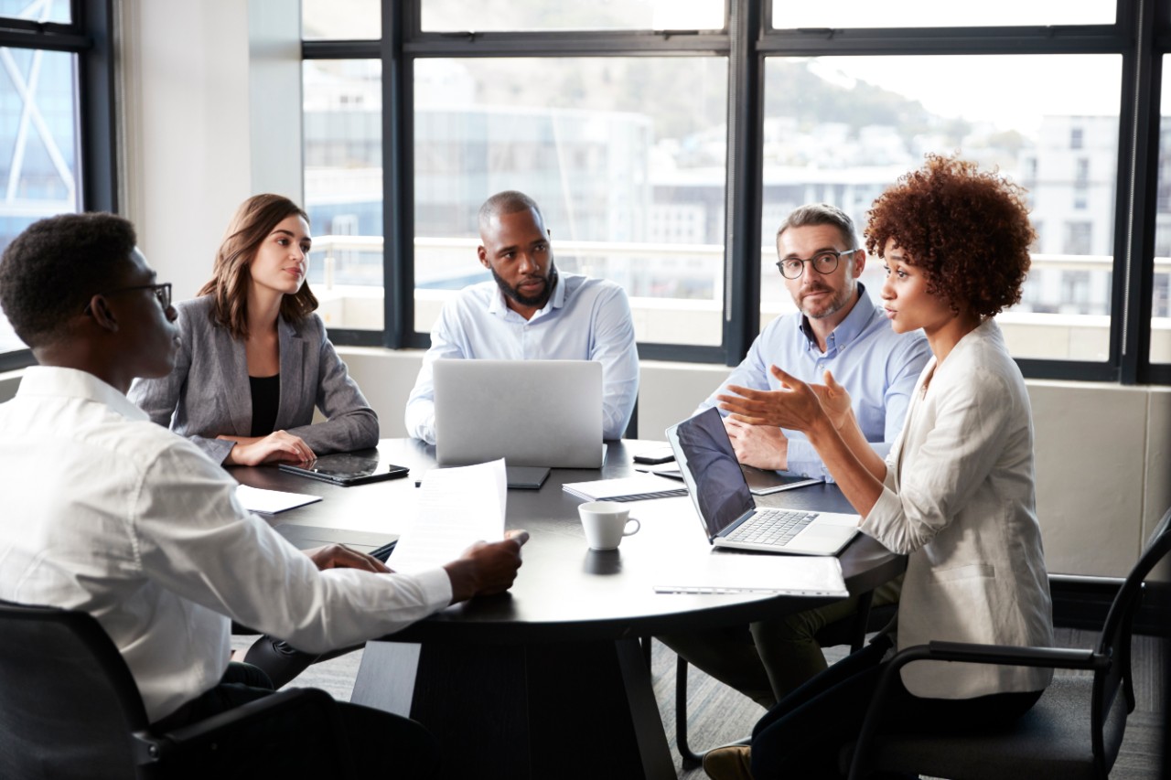 1146472948 Millennial black businesswoman addressing colleagues at a corporate business meeting, close up